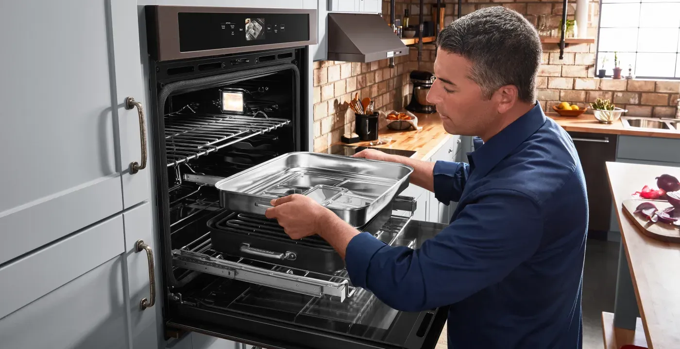 kitchenaid-smart-single-oven-man-adding-pan-KOSE900HBS